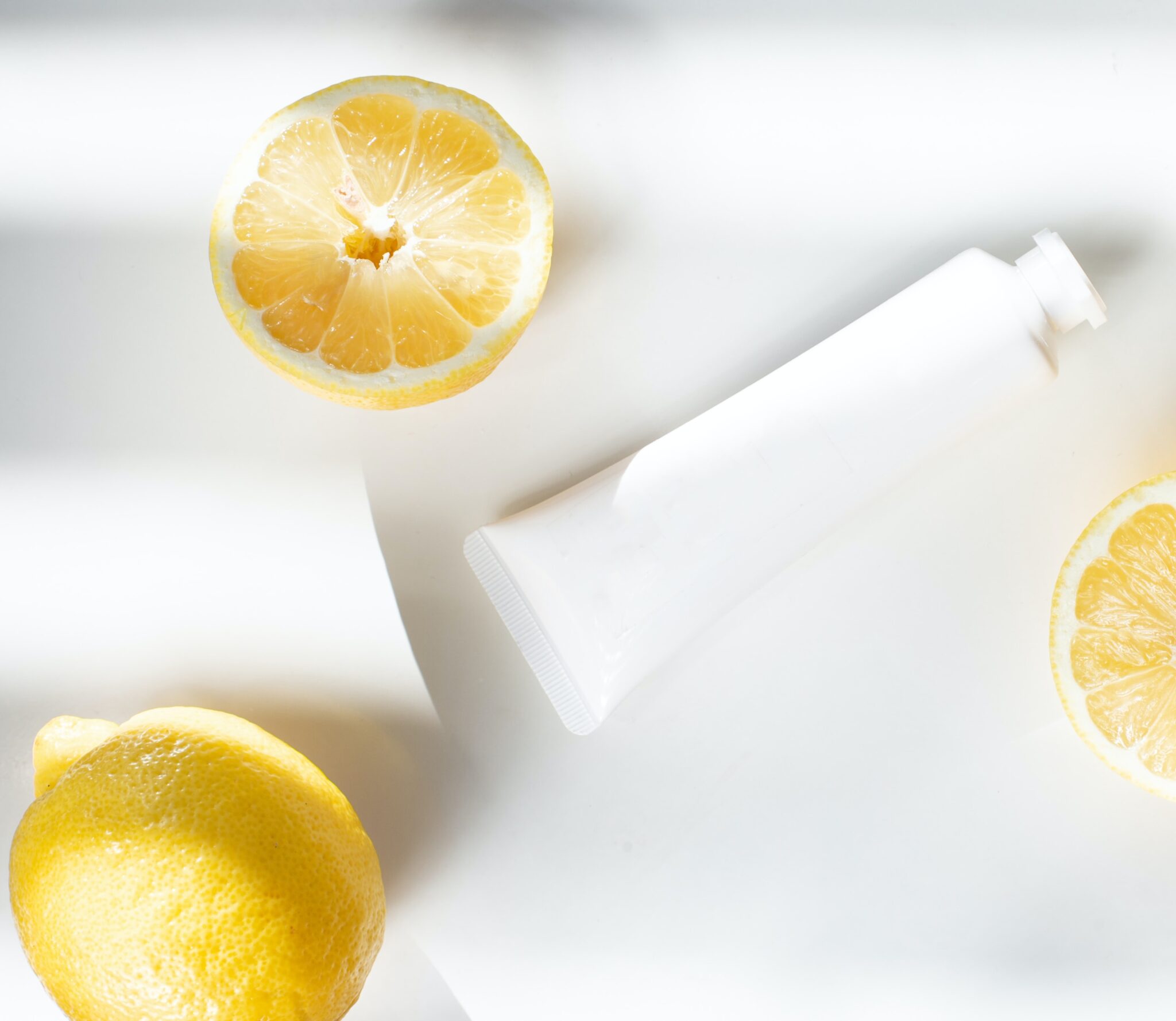 Sliced lemon beside white ceramic container photo © Birgith Roosipuu