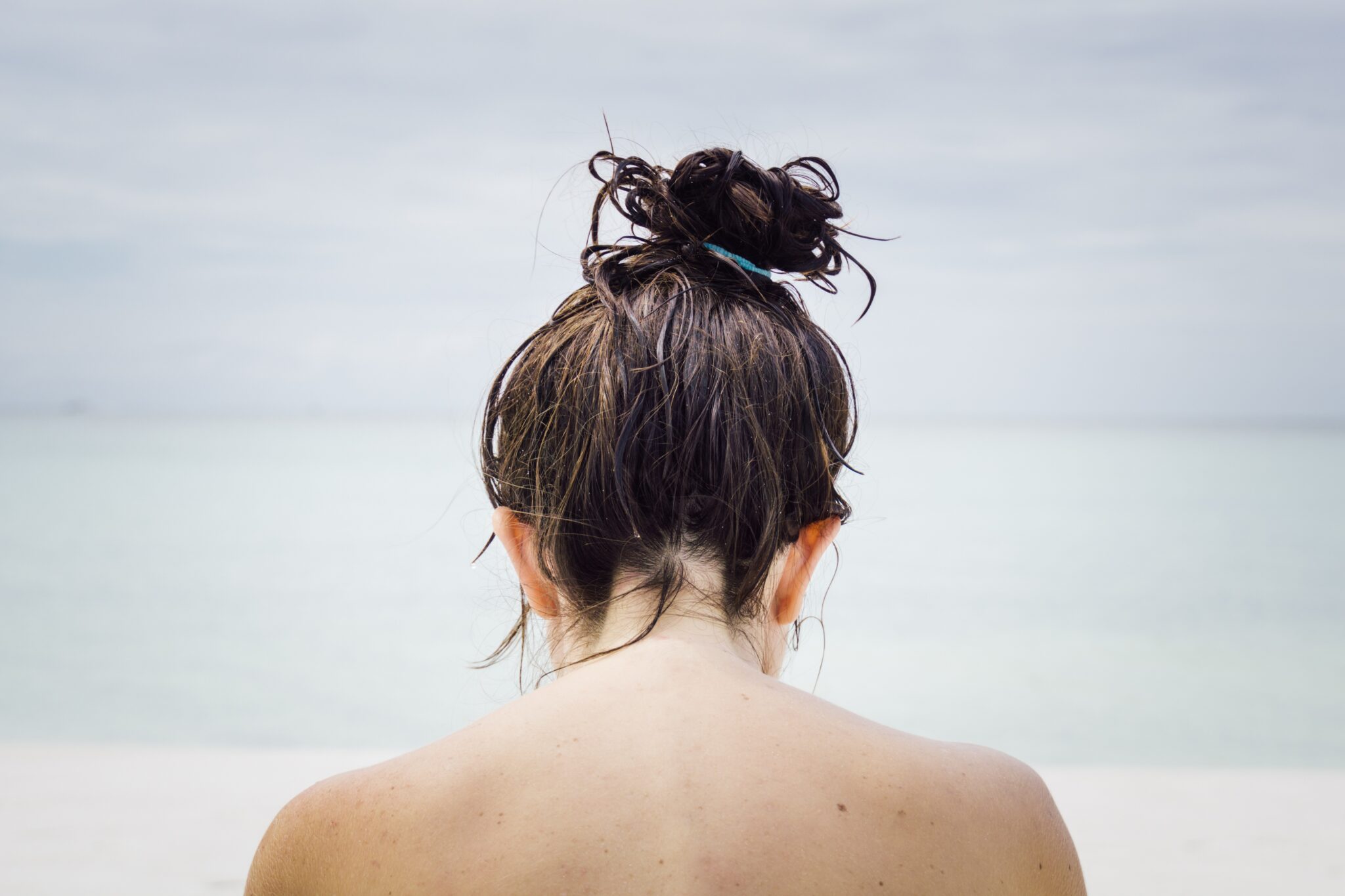 Woman facing seashore by Chris Slupski